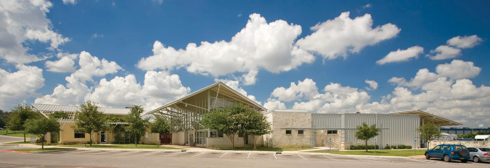 Contemporary commercial building with an angled roofline under a cloudy sky